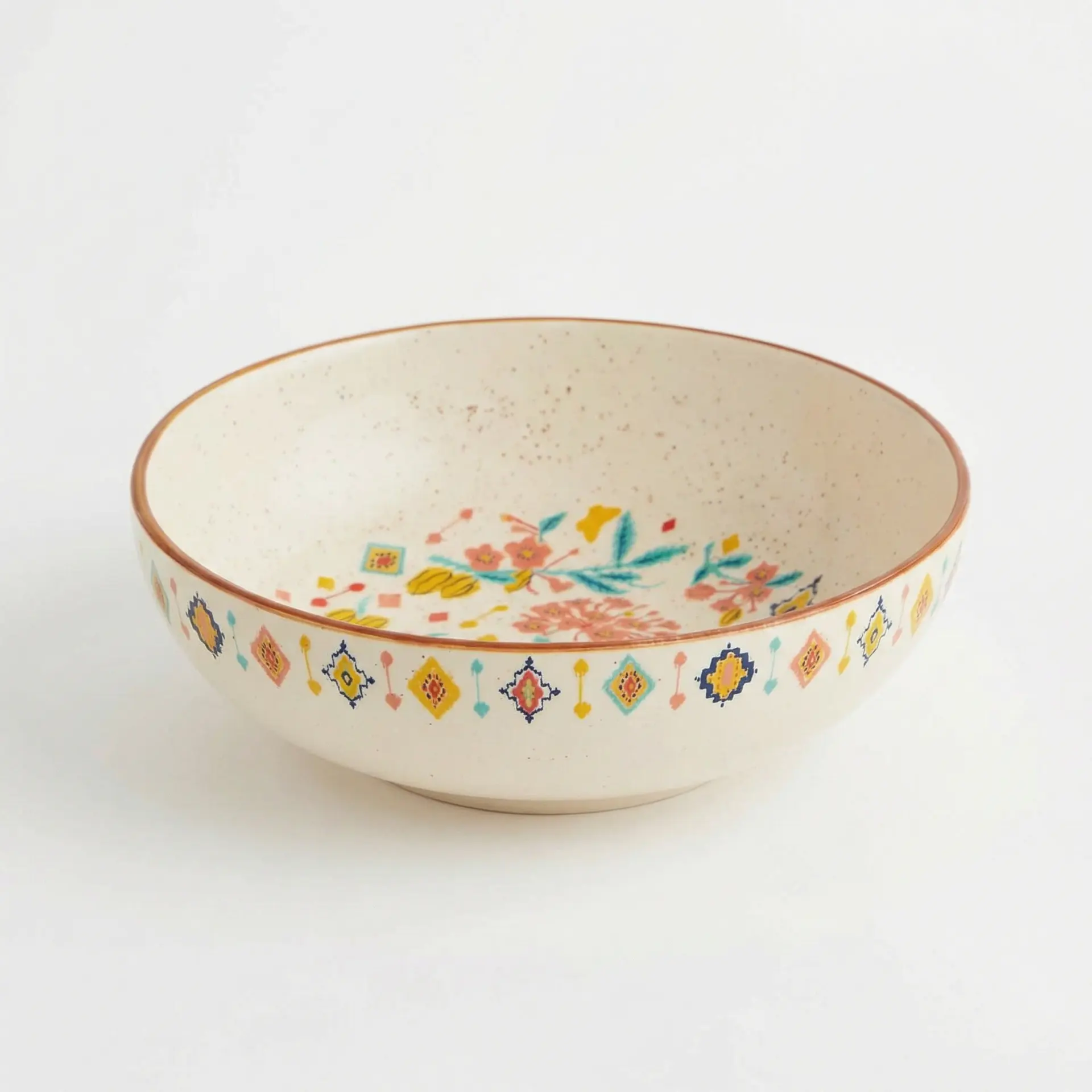 Decorative ceramic bowl with cream speckled glaze and colorful floral patterns